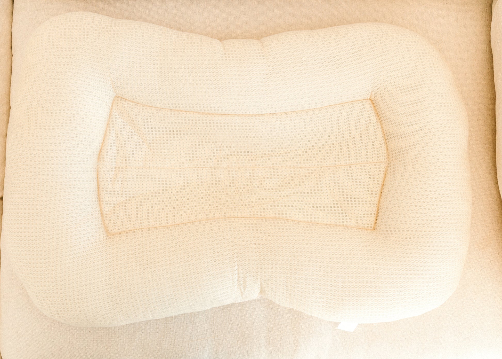 Close-up of a beige textured fabric surface